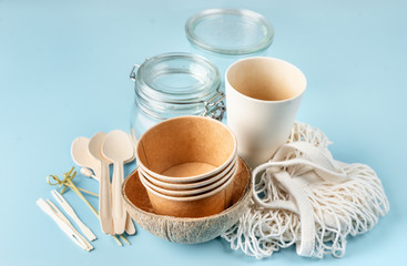 Eco tableware. Paper and bamboo cups, bag and wooden cutlery.