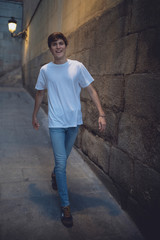 young man walking through a deserted street