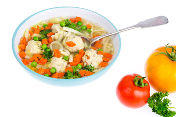 Chicken broth with vegetables, pasta and meatballs.