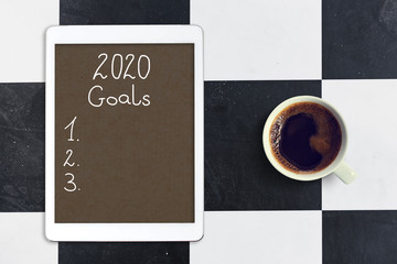List of goals for 2020 year. Top view on the desk.