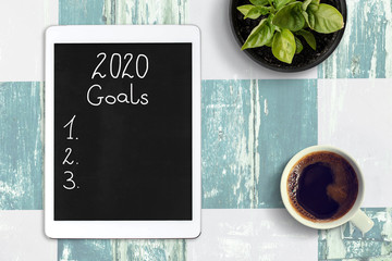 List of goals for 2020 year. Top view on the desk.