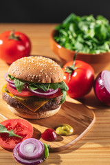 Delicious hamburger with vegetable ingredients like tomato, lettuce, onion and cheese