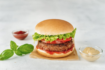 Homemade vegan burger on white rustic background
