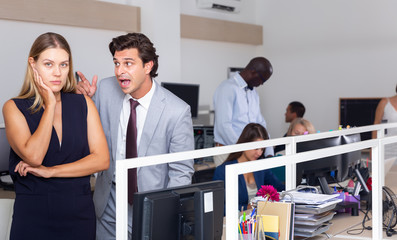 Angry boss blaming young woman office worker