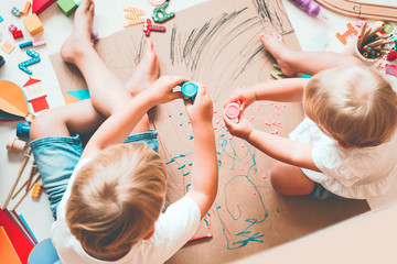 Obraz na płótnie Canvas Kids draw and make crafts. Kindergarten or preschool background.