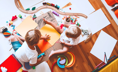 Kids draw and make crafts. Kindergarten or preschool background.