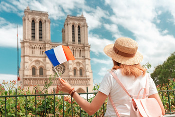 Fototapeta premium Happy asian woman visiting famous Notre Dame Cathedral after the Fire. Europe travel and sightseeing tours concept