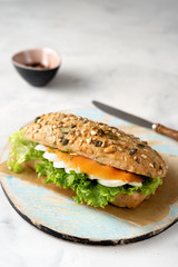 Healthy sandwich with salmon on white background