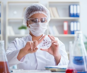 Female scientist researcher conducting an experiment in a labora