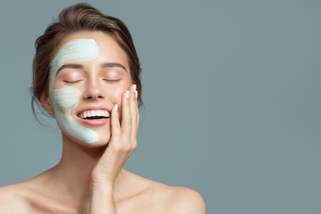 Portrait of beautiful woman with bluel cream mask on her face. - 288792134