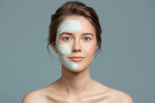 Portrait Of Beautiful Woman With Bluel Cream Mask On Her Face.