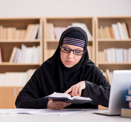 Muslim girl in hijab studying preparing for exams