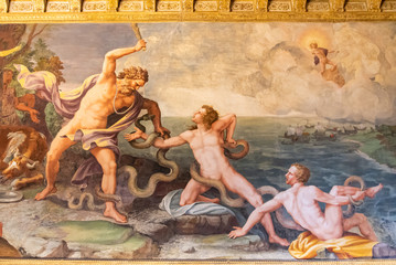Ancient classical painting showing three naked man fighting against snakes next to the sea