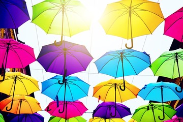 Fototapeta na wymiar Umbrellas in the air . bright small streets of the city