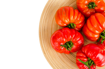Red fresh beefsteak tomatoes on white background.