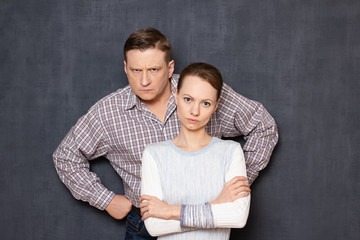 Portrait of serious and dissatisfied caucasian man and woman