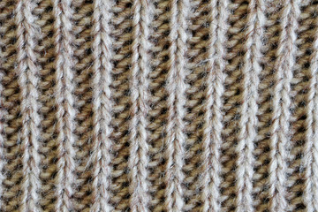 Knit woolen fabric with a vertical pattern. Warm clothes for winter and autumn cold. Texture for design or research