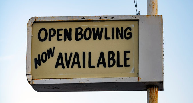 Old Rusted Lighted Sign at Recreation Center says Open Bowling