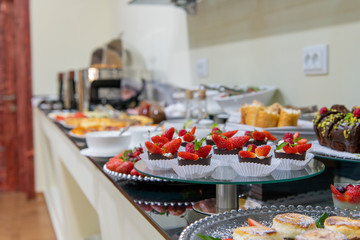 Fruit tart with raspberries and cream, cakes and sweetness on holiday background. Delicious dessert and candy bar.