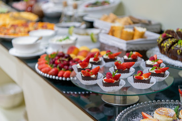 A tasty sweet dessert with creme and strawberries on a breakfast buffet at a hotel.