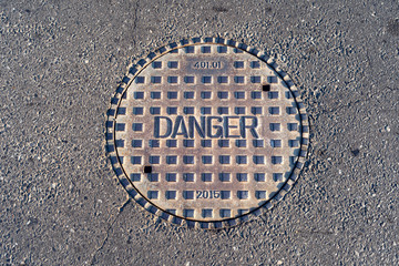 Closed manhole cover on a city street 