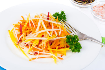Tasty vegetarian salad of colorful carrots on white background.