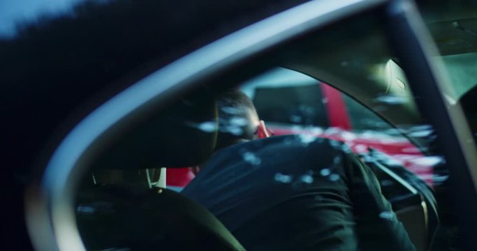 Business Young Man In Black Suit Getting Out Of Modern Car Holding Smartphone Device In Hand Going Home On Beautiful Street Outdoor. Close-up.