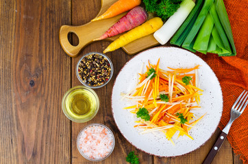 Dietary vegetable carrot salad on wooden background