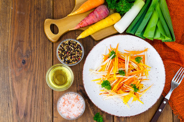 Dietary vegetable carrot salad on wooden background