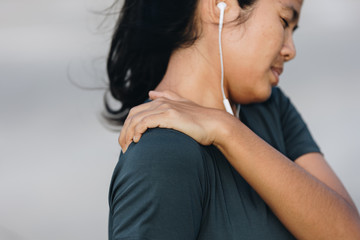 Fototapeta premium Young asian women shoulder pain after exercise, healthy lifestyle and sport concepts