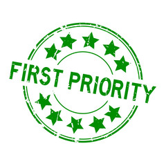 Grunge green first priority word with star icon round rubber seal stamp on white background