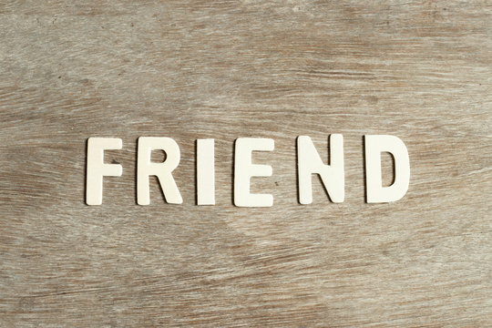 Alphabet letter in word firend on wood background