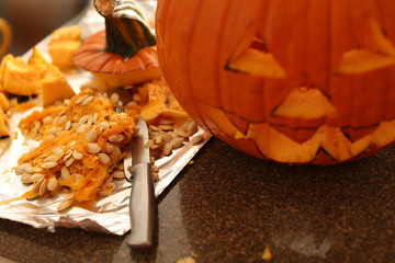 cutting open a jack-o-lantern
