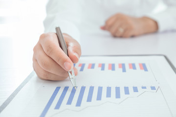 Businessman analyzes signing financial statements
