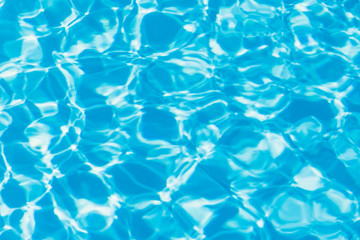 Blue pool water with sun reflections