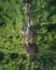 Beautiful aerial view of a waterfall at sunrise in the middle of a rainforest.  Beautiful hike, walk, adventure location in Australia, Queensland, Twin Falls circuit