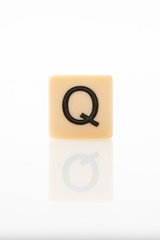 Alphabet Q word block with white background.