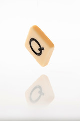 Alphabet Q word block with white background.