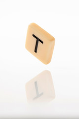 Alphabet T word block with white background.
