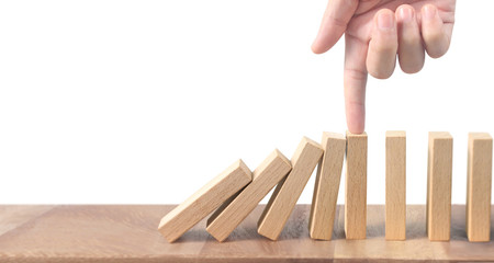 Hand stopping  Domino effect stopped by unique