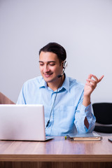 Call center operator working at his desk