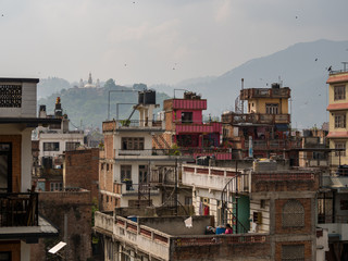 Fototapeta na wymiar Kathmandu Rooftops, Stupa, Crowded City Skyline in Nepal