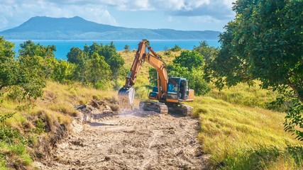 Showing environmental damage for the purpose of tourism, as a new public road is being constructed to provide access to develop virgin land in the Philippines.