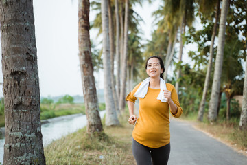 pregnant woman jogging outdoor in nature. active maternity lifestyle