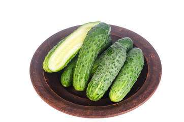 Fresh green cucumbers on ceramic bowl. Photo