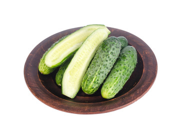 Fresh green cucumbers on ceramic bowl. Photo
