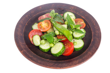 Fresh cucumber, tomato, green peas on ceramic bowl.