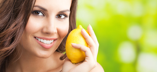 Young happy smiling woman with limon, outdoors