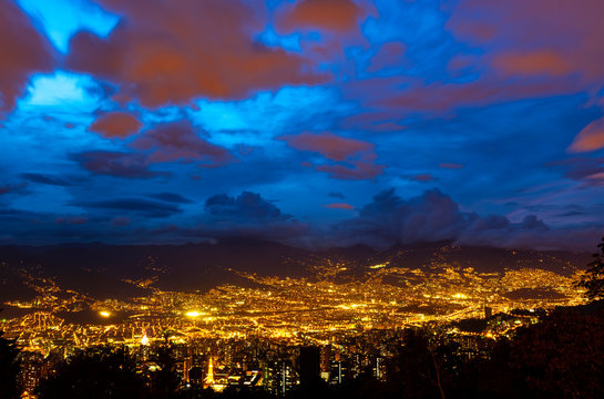 Long exposure photography of Medellin cityscape during the blue hour with the city lights in the Andes mountains, Antioquia department, Colombia.