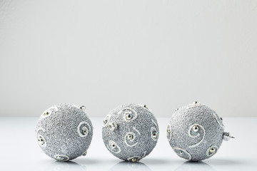 Three clear christmas balls with glitter stripes